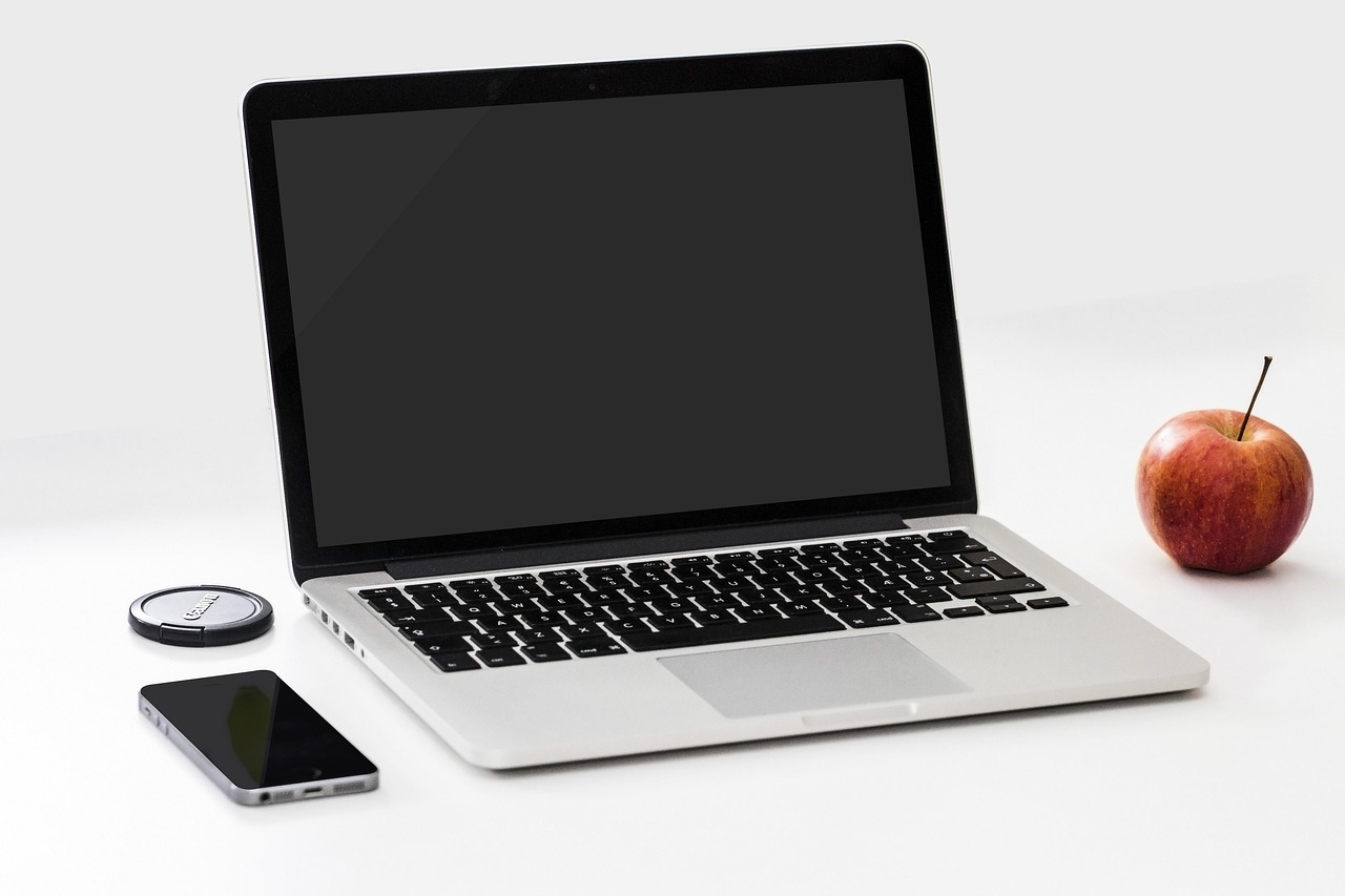 Apple, smartphone, desk — Electric Motors in Renewable Energy: Powering a Sustainable Future